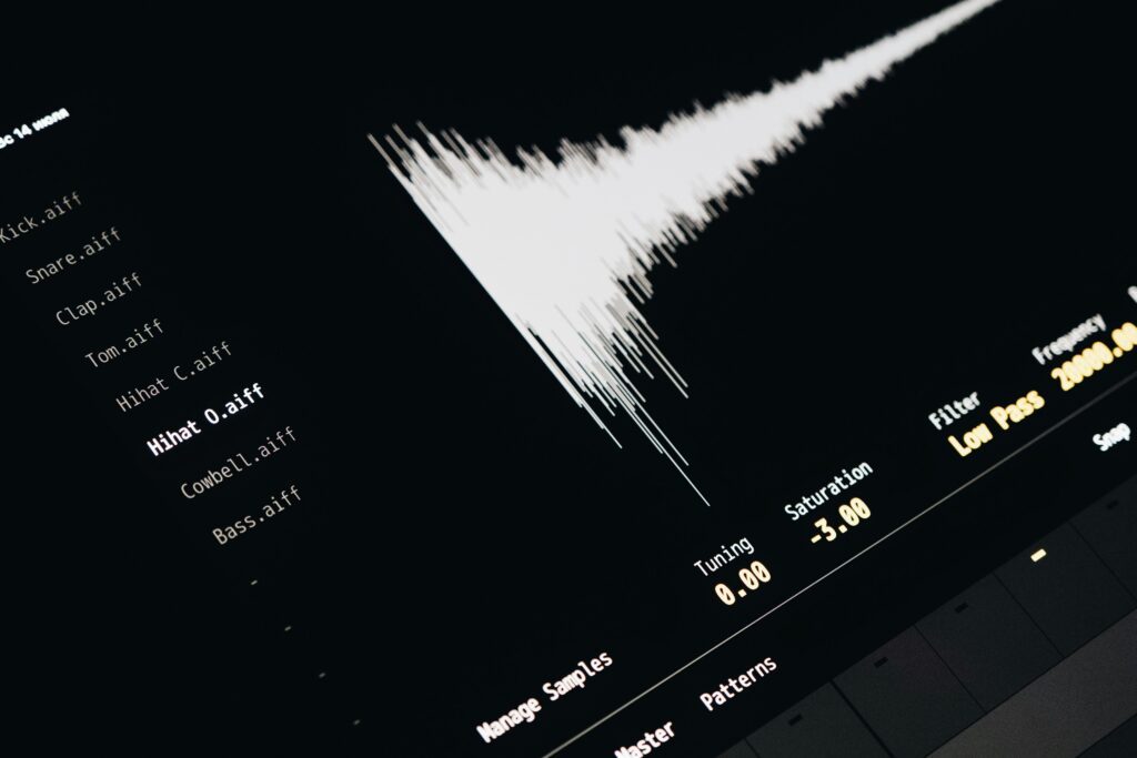 Close-up of a digital audio editing interface displaying sound waves and file names.